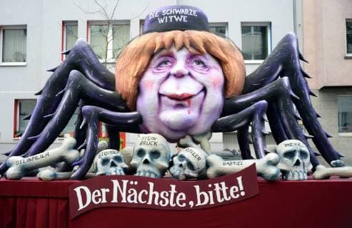 Germany NRW Düsseldorf parade theme railcars by Jaques Tilly Angela Merkel as black widow the next please