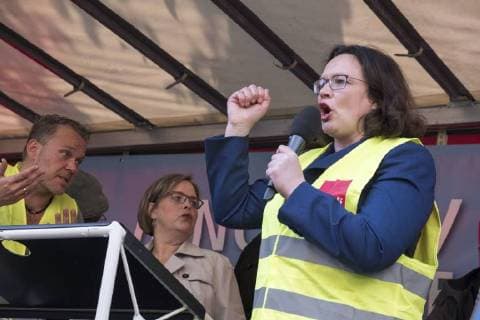 Party leader Andrea Nahles SPD speaks to Amazon employees during a protest action by the United Services Union ver di against the award of the Axel Springer Award to Amazon boss Jeff Bezos in front of Axel Springer Verlag in Berlin Employees protest against the presentation of the Axel Springer Award to Amazon boss Bezos