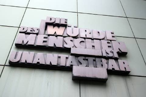 Sculpture with article one of the Basic Law of the Federal Republic of Germany the dignity of man is inviolable on the facade of the public prosecutors office in the justice center in the city center Frankfurt Hessen Germany