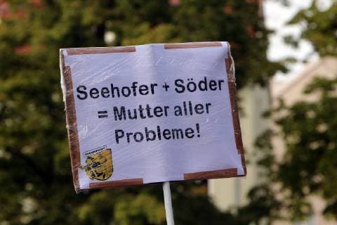 Under the hashtag Speculated tens of thousands of people demonstrated against rising rents and affordable housing in Munich Bavaria Germany demonstrator with poster Seehofer and Söder are the mother of all problems