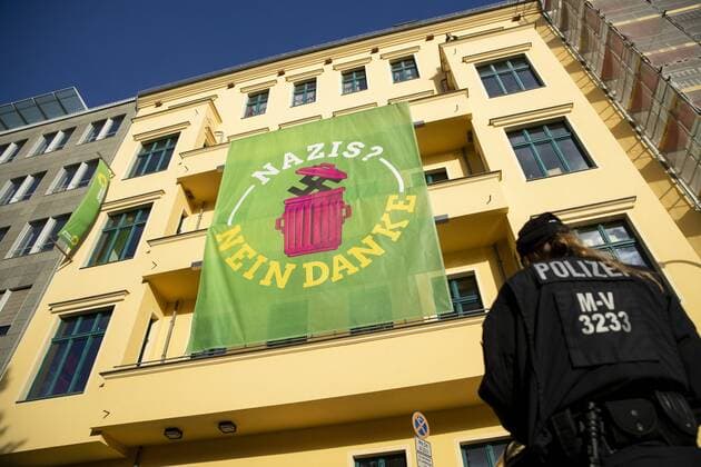 A giant banner hangs in front of the facade of the Gruenen Nazis building office No Thanks on the verge of a demonstration organized by the right-wing populist organization We for Germany with the motto Day of the Nation on the Day of German Unity in Berlin on 3 October 2018 Day of German Unity in Berlin