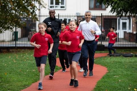October 15, 2018 - London, London, UK - London, UK. Mayor of London Sadiq Khan (right) and British athlete Sir Mohamed Farah (left) launch a campaign at Cubitt Town Junior School to encourage London schools to take part in the Daily Mile initiative. The Daily Mile gets school children exercising outside for 15 minutes a day, to improve their physical, social, emotional and mental health and wellbeing. London UK - ZUMAl94_ 20181015_zaf_l94_056 Copyright: xTomxNicholsonx