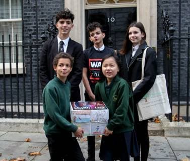November 19, 2018 - London, United Kingdom - A group of school children are seen holding a petition by the Child War before handing it to the Prime Minister..The petition is a Learn to live campaign which urges the British Prime Minister Theresa May and other world leaders to better support the mental health and the emotional needs of the children affected by conflict. Even when children escape the bombs, the trauma of war can stay with them for years. London United Kingdom - ZUMAs197 20181119_zaa_s197_039 Copyright: xDinendraxHariax