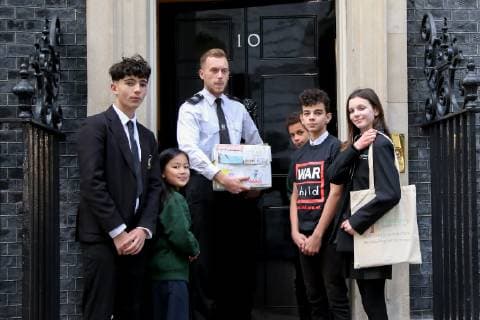 November 19, 2018 - London, United Kingdom - A group of school children are seen handing a petition by the Child War to the Prime Minister..The petition is a Learn to live campaign which urges the British Prime Minister Theresa May and other world leaders to better support the mental health and the emotional needs of the children affected by conflict. Even when children escape the bombs, the trauma of war can stay with them for years. London United Kingdom - ZUMAs197 20181119_zaa_s197_037 Copyright: xDinendraxHariax