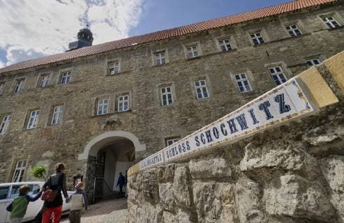 Visitors come on Sunday 15 05 11 to the ceremonial inauguration of the statue of the Virgin Mary in Schochwitz Castle Saalekreis The 10 meter high figure was carved from a tree trunk It is supposed to be the largest carved figure of the Virgin Mary in Europe The 12 century castle is used by the Scotsman Lord Jam