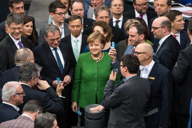 Politics Bundestag Session of the German Bundestag on Thursday 21 February 2019 In the picture The members of parliament vote by name on the amendment of the Basic Law to introduce the so-called digital pact With a green suit jacket Chancellor Angela Merkel CDU 21 2 2019 Berlin