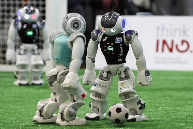 Football robots play football here the teams of B Human Black Jerseys vs Berlin United Final Stand 7 0 RoboCup German Open 2019 in the exhibition halls in Magdeburg Photographed on 03 05 2019
