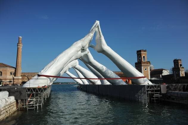The sculptor Lorenzo Quinn son of the late US star actor Anthony Quinn unveils his work of art BUILDING BRIDGES Costruendo Ponti in Venice on the occasion of the Art Biennale Venezia 2019 It shows giant hands including the water Photo The work of art in Arsenale Venezia