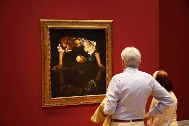 A man and a woman are looking at the painting Narcissus by Michelangelo Merisi da Caravaggio, Oil on canvas, 1597 1599 during a tour as part of the press conference on the exhibition Wege des Barock at the Museum Barberini in Potsdam, 11 July 2019 Exhibition period 13 July to 6 October 2019 Museum Barberini Exhibition Paths of the Baroque