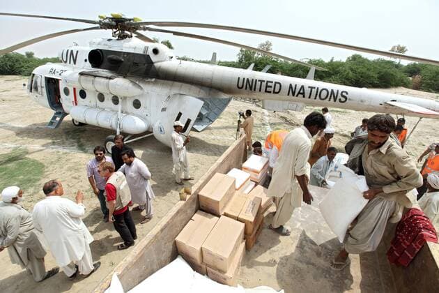 Kotnai, Pakistan Flood Natural Disaster, WFP Helicopter with food 30 08 2010, Kotnai, Union Council Lakhani, Pakistan, PAK Flood Natural Disaster Unloading a WFP World Food Programme of the United Nations Helicopter with relief supplies for victims of the flood Kotnai Union Council Lakhani Pakistan