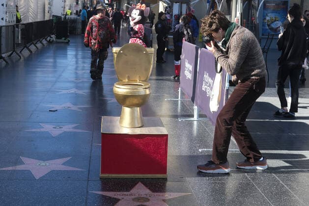 December 15, 2019, Los Angeles, California, U.S: A man takes photos a symbolic toilet is put in near the star of Donald Trump on the Hollywood Walk of Fame Sunday, December 15, 2019. Los Angeles U.S. - ZUMAc68_ 20191215_zaf_c68_007 Copyright: xRingoxChiux