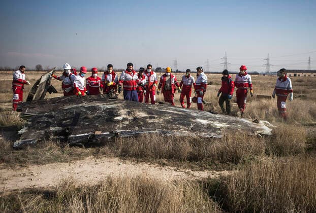 Bilder des Jahres 2020, News 01 Januar (200108) -- TEHRAN, Jan. 8, 2020 -- Rescuers work at the air crash site of a Boeing 737 Ukrainian passenger plane in Parand district, southern Tehran, Iran, on Jan. 8, 2020. All the passengers and crew members on board the Boeing 737 Ukrainian passenger plane that crashed near Tehran Imam Khomeini International Airport (IKA) on Wednesday morning are confirmed dead, official Islamic Republic News Agency (IRNA) reported. (Photo by Xinhua) (SPOT NEWS)IRAN-TEHRAN-UKRAINIAN PASSENGER PLANE-CRASH AhmadxHalabisaz 