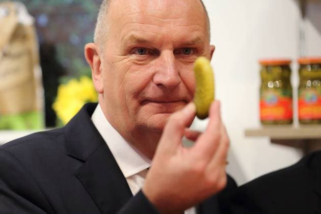 Minister President Dietmar Woidke SPD looks at a Spreewald gherkin before tasting it during a tour of Brandenburg Day at the Green Week in Berlin, 20 January 2020 Green Week Brandenburg Day