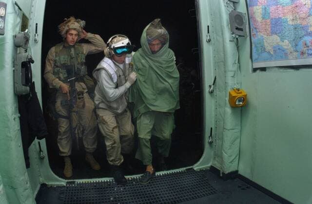 U.S. Sailor and a Marine bring a wounded Pashtun fighter from Afghanistan aboard the USS Bataan for medical treatment in the first months of the U.S. fighting after the al Qaeda 9 11 terrorist attacks. Dec. 6 2001., Photo by:Everett Collection(BSLOC_2011_ Everett Collection(BSLOC_2011_6_80) PUBLICATIONXNOTxINxCANxCHNxFRAxITAxJPNxNORxPOLxRUSxESPxUKxUSA Copyright: xCourtesyxEverettxCollectionx HISL024 EC172