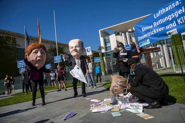 Campact activists and other demonstrators protest against rescue aid for the airline Lufthansa in front of the Chancellors Office in Berlin on 27 May 2020