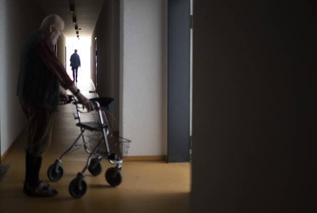Theme Man with walker in a dark hallway Heidelberg Germany Copyright: xUtexGrabowsky photothek.netx