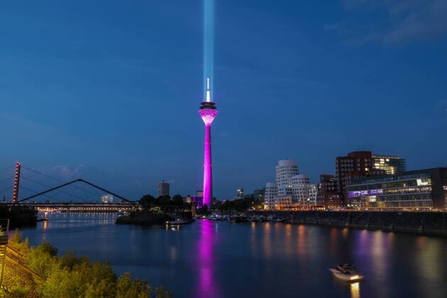 Lighting of the Rhine Tower Düsseldorf Rhine Tower Düsseldorf for Telekoms advertising campaign in magenta based on the model of the Rhine comet lights up Düsseldorf Speditionsstraße North Rhine-Westphalia Germany