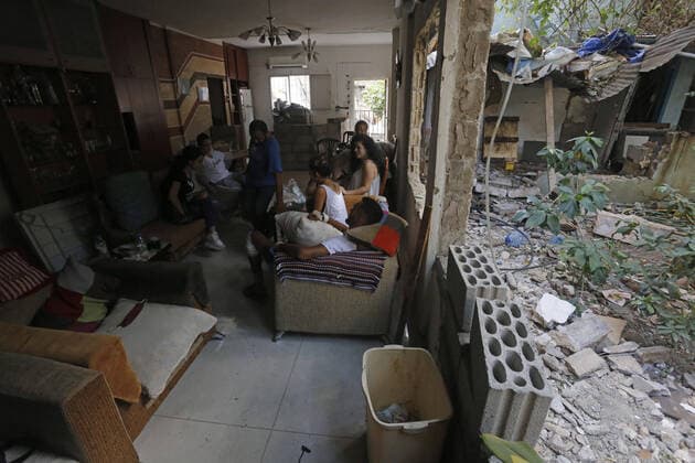 September 9, 2020, Beirut, Beirut, Lebanon: A Lebanese family sit inside their destroyed home which was disrupted by a blast in Beirut s port area, Lebanon August 9, 2020, in the aftermath of a colossal explosion that occurred days prior due to a huge pile of ammonium nitrate that had languished for years at a port warehouse. The huge chemical explosion that hit Beirut s port, devastating large parts of the Lebanese capital and claiming over 150 lives, left a 43-metre (141 foot) deep crater, a security official said. The blast Tuesday, which was felt across the country and as far as the island of Cyprus, was recorded by the sensors of the American Institute of Geophysics (USGS) as having the power of a magnitude 3.3 earthquake Beirut Leba - ZUMAap3_ 20200909_zaf_ap3_023 Copyright: xMarwanxTahtahx