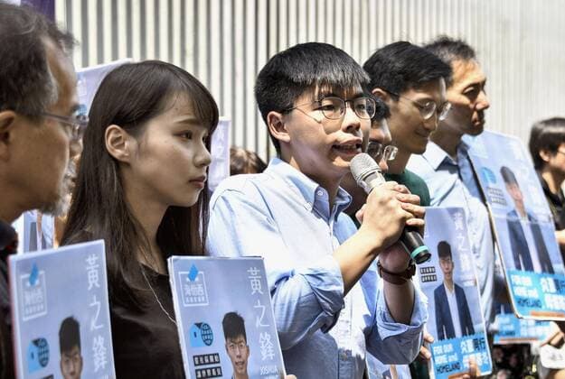 Hong Kong pro-democracy activist Joshua Wong Photo taken in Hong Kong on Sept. 28, 2019, shows pro-democracy activist Joshua Wong (3rd from L) announcing a plan to run in the District Council election. Fellow activist Agnes Chow (2nd from L) stands next to him. 