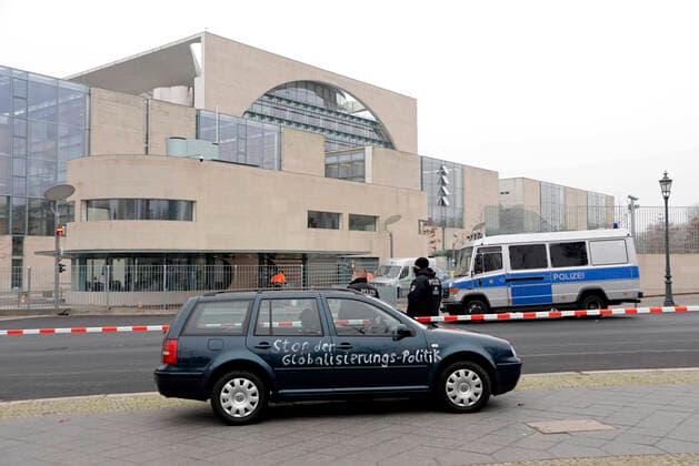 25 11 2020 , Berlin Mitte This morning a dark car has reached the entrance gate of the Federal Chancellery The car is marked Stop Globalization Policy and You Damned Children and Old People Murderers