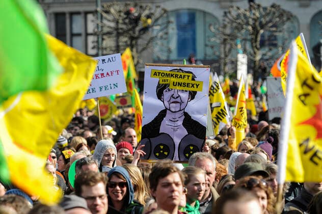 DEUTSCHLAND, Hamburg, DEMO fuer Atomausstieg nach Havarie im AKW Fukushima in Japan, Plakat mit Bild der Bundeskanzlerin Angela Merkel mit Schriftzug Atomkraft ist unsexy Hamburg Germany