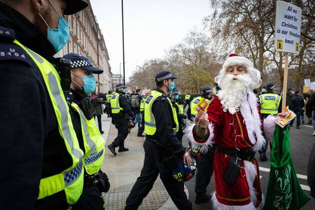 November 28, 2020, London, United Kingdom: Santa Claus marching next to police officers during the demonstration..Lockdown protesters take to the streets again. The Save Our Rights movement, organised the rally to unite people for freedom, justice and to develop a real democracy which they see as being under threat due to The Coronavirus Act. London United Kingdom - ZUMAs197 20201128_zaa_s197_063 Copyright: xAndyxBartonx