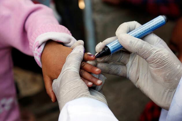 (201128) -- SANAA, Nov. 28, 2020 -- A medical worker marks a child s finger after giving her a dose of polio vaccine in Sanaa, Yemen, on Nov. 28, 2020. Yemen s health authorities on Saturday launched a polio vaccination campaign for more than 4 million children in the north of the war-torn country. The three-day campaign is supported by the World Health Organization, the UNICEF and other international aid agencies, the local health authorities said in a statement. (Photo by Xinhua) YEMEN-SANAA-CHILDREN-POLIO VACCINATION MohammedxMohammed 