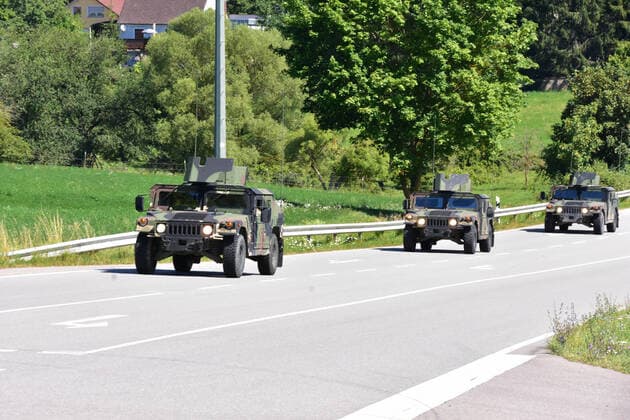 US Army vehicles in a column US Army vehicles are driving in a column near Grafenwöhr Hörmannsdorf Bavaria Germany