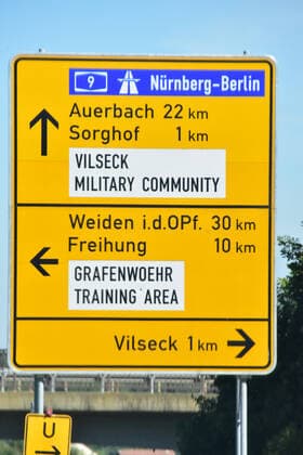 City sign of the city of Vilseck in the Upper Palatinate Street sign in the area of the city of Vilseck with hints to the military training area of the US Army in Grafenwöhr Vilseck Bavaria Germany