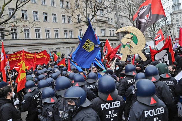 Luxemburg and Liebknecht demonstration 10 1 2021 police gather under FDJ flag and hammer and sickle in gold Berlin Berlin GER