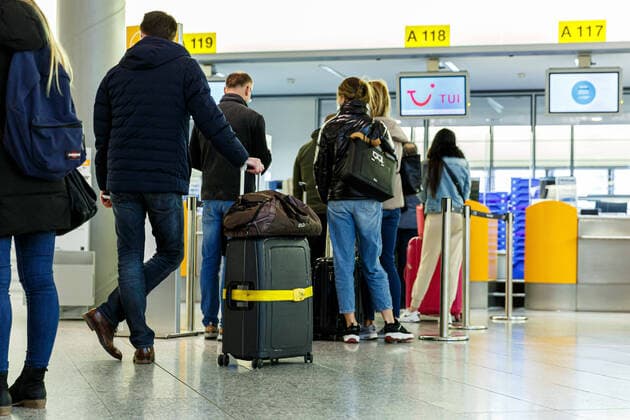 GERMANY, LOWER SAXONY, LANGENHAGEN, 21 03 2021 First flight to Mallorca Hannover Langenhagen Airport Travellers wait in a queue at check-in for one of the first flights to Palma de Mallorca with TUI fly The first flights to Palma de Mallorca are taking off again today at Hannover Langenhagen Airport.