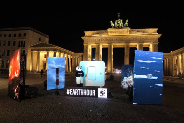 On the occasion of the climate protection campaign Earth Hour, the lights at the Brandenburg Gate were switched off at 8.30 pm on Saturday 27 03 2020 Four large screens on Pariser Platz show images of destroyed ecosystems before the lights go out Afterwards, they are replaced by images of intact oceans and healthy forests Berlin Germany Europe