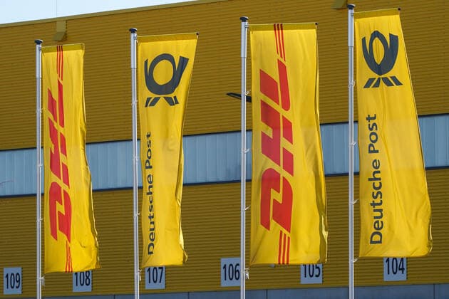 Logistics service provider DHL and Deutsche Post The logos DHL of the parcel and letter express service DHL International GmbH, which belongs to the Deutsche Post DHL Group, and Deutsche Post, the German postal company Deutsche Post AG, can be seen on flags Leipzig Saxony Germany