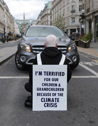 May 1, 2021, London, England, United Kingdom: An Extinction Rebellion activist blocks the road in Oxford Circus. Protester carries a sign that reads Ã¢â‚¬oeI am terrified for my children and grandchildren because of the climate crisis. London United Kingdom - ZUMAs262 20210501_zip_s262_001 Copyright: xTayfunxSalcix