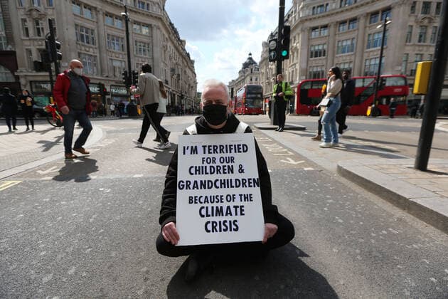 May 1, 2021, London, England, United Kingdom: An Extinction Rebellion activist blocks the road in Oxford Circus. Protester carries a sign that reads Ã¢â‚¬oeI am terrified for my children and grandchildren because of the climate crisis. London United Kingdom - ZUMAs262 20210501_zip_s262_005 Copyright: xTayfunxSalcix