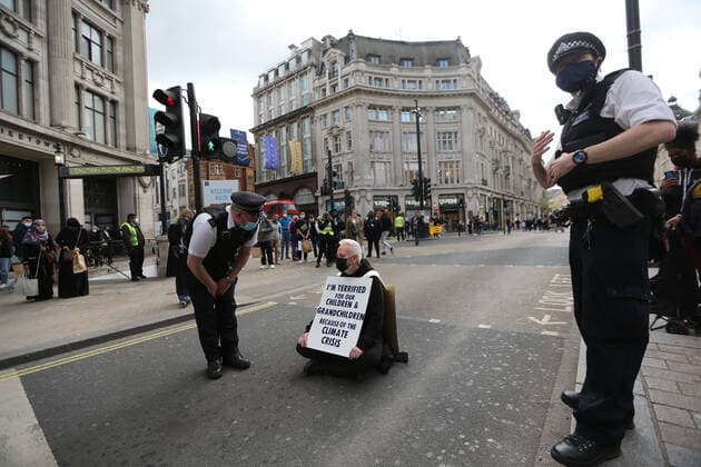 May 1, 2021, London, England, United Kingdom: An Extinction Rebellion activist blocks the road in Oxford Circus. Protester carries a sign that reads Ã¢â‚¬oeI am terrified for my children and grandchildren because of the climate crisis. London United Kingdom - ZUMAs262 20210501_zip_s262_009 Copyright: xTayfunxSalcix