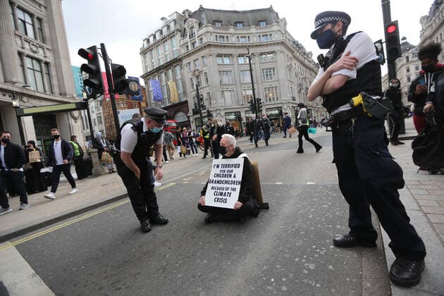 May 1, 2021, London, England, United Kingdom: An Extinction Rebellion activist blocks the road in Oxford Circus. Protester carries a sign that reads Ã¢â‚¬oeI am terrified for my children and grandchildren because of the climate crisis. London United Kingdom - ZUMAs262 20210501_zip_s262_010 Copyright: xTayfunxSalcix