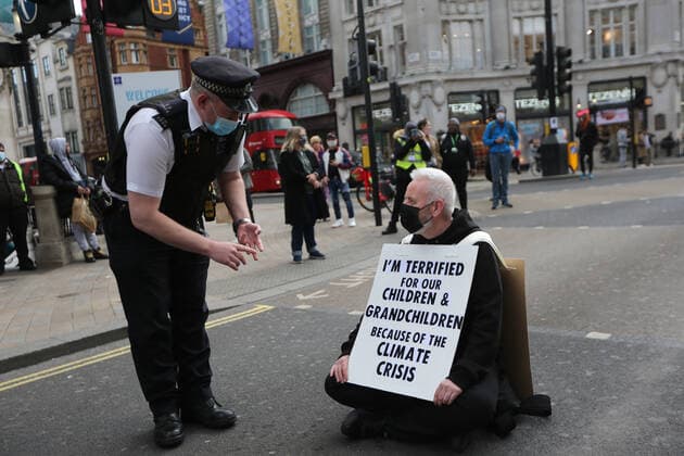 May 1, 2021, London, England, United Kingdom: An Extinction Rebellion activist blocks the road in Oxford Circus. Protester carries a sign that reads Ã¢â‚¬oeI am terrified for my children and grandchildren because of the climate crisis. London United Kingdom - ZUMAs262 20210501_zip_s262_011 Copyright: xTayfunxSalcix