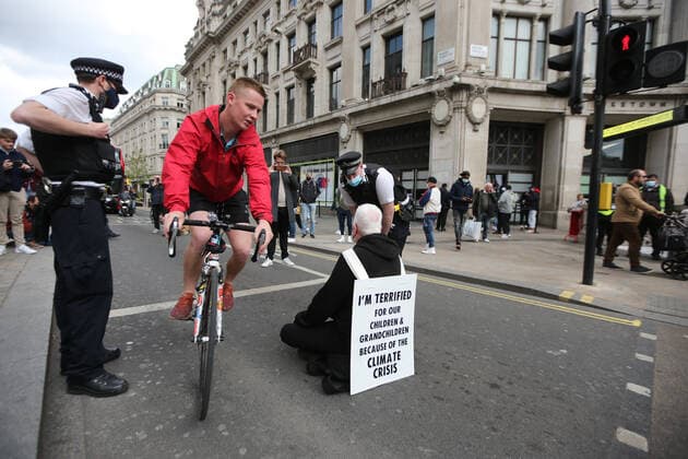May 1, 2021, London, England, United Kingdom: An Extinction Rebellion activist blocks the road in Oxford Circus. Protester carries a sign that reads Ã¢â‚¬oeI am terrified for my children and grandchildren because of the climate crisis. London United Kingdom - ZUMAs262 20210501_zip_s262_012 Copyright: xTayfunxSalcix