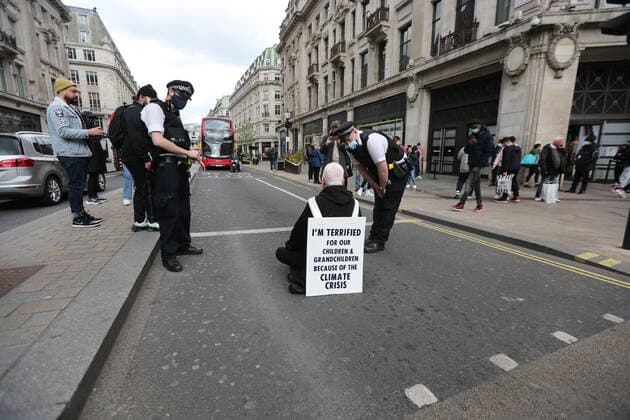May 1, 2021, London, England, United Kingdom: An Extinction Rebellion activist blocks the road in Oxford Circus. Protester carries a sign that reads Ã¢â‚¬oeI am terrified for my children and grandchildren because of the climate crisis. London United Kingdom - ZUMAs262 20210501_zip_s262_013 Copyright: xTayfunxSalcix