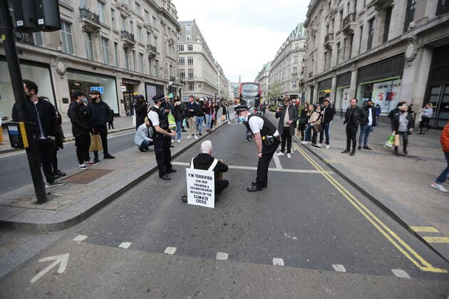 May 1, 2021, London, England, United Kingdom: An Extinction Rebellion activist blocks the road in Oxford Circus. Protester carries a sign that reads Ã¢â‚¬oeI am terrified for my children and grandchildren because of the climate crisis. London United Kingdom - ZUMAs262 20210501_zip_s262_014 Copyright: xTayfunxSalcix