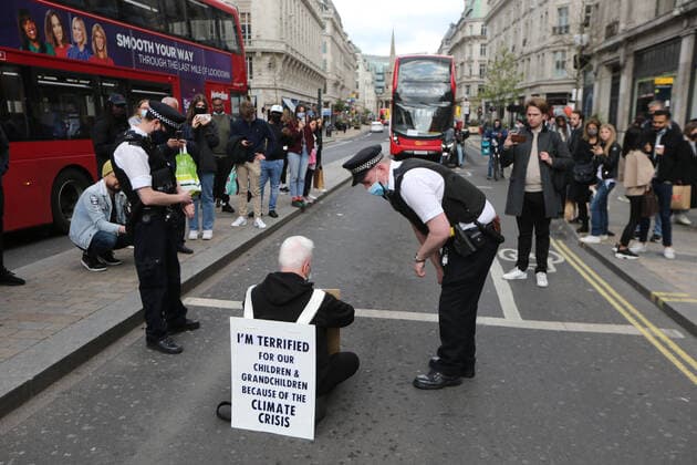 May 1, 2021, London, England, United Kingdom: An Extinction Rebellion activist blocks the road in Oxford Circus. Protester carries a sign that reads Ã¢â‚¬oeI am terrified for my children and grandchildren because of the climate crisis. London United Kingdom - ZUMAs262 20210501_zip_s262_015 Copyright: xTayfunxSalcix
