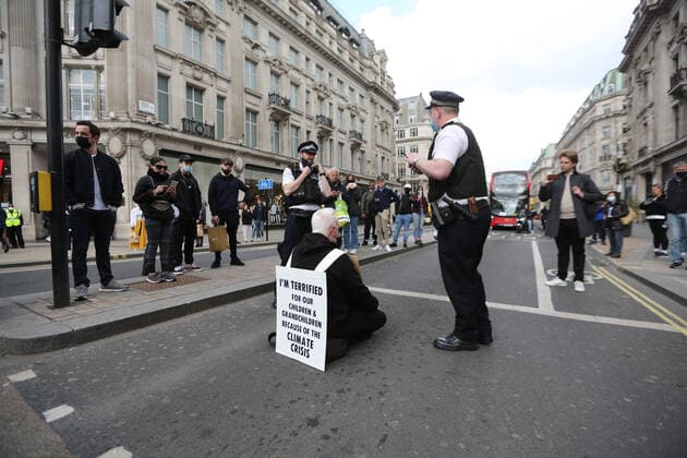 May 1, 2021, London, England, United Kingdom: An Extinction Rebellion activist blocks the road in Oxford Circus. Protester carries a sign that reads Ã¢â‚¬oeI am terrified for my children and grandchildren because of the climate crisis. London United Kingdom - ZUMAs262 20210501_zip_s262_016 Copyright: xTayfunxSalcix