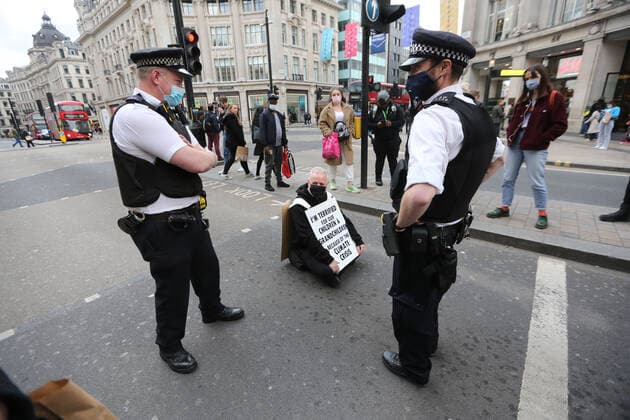 May 1, 2021, London, England, United Kingdom: An Extinction Rebellion activist blocks the road in Oxford Circus. Protester carries a sign that reads Ã¢â‚¬oeI am terrified for my children and grandchildren because of the climate crisis. London United Kingdom - ZUMAs262 20210501_zip_s262_017 Copyright: xTayfunxSalcix