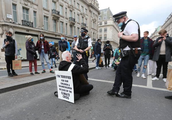 May 1, 2021, London, England, United Kingdom: An Extinction Rebellion activist blocks the road in Oxford Circus. Protester carries a sign that reads Ã¢â‚¬oeI am terrified for my children and grandchildren because of the climate crisis. London United Kingdom - ZUMAs262 20210501_zip_s262_018 Copyright: xTayfunxSalcix