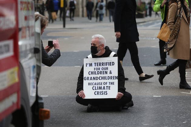 May 1, 2021, London, England, United Kingdom: An Extinction Rebellion activist blocks the road in Oxford Circus. Protester carries a sign that reads Ã¢â‚¬oeI am terrified for my children and grandchildren because of the climate crisis. London United Kingdom - ZUMAs262 20210501_zip_s262_019 Copyright: xTayfunxSalcix
