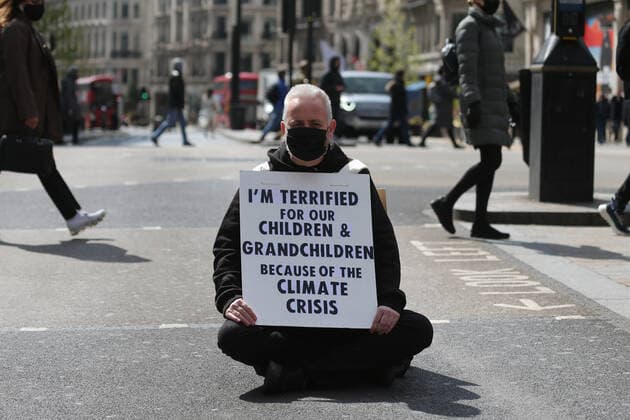 May 1, 2021, London, England, United Kingdom: An Extinction Rebellion activist blocks the road in Oxford Circus. Protester carries a sign that reads Ã¢â‚¬oeI am terrified for my children and grandchildren because of the climate crisis. London United Kingdom - ZUMAs262 20210501_zip_s262_020 Copyright: xTayfunxSalcix