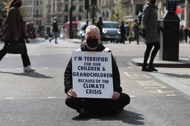May 1, 2021, London, England, United Kingdom: An Extinction Rebellion activist blocks the road in Oxford Circus. Protester carries a sign that reads Ã¢â‚¬oeI am terrified for my children and grandchildren because of the climate crisis. London United Kingdom - ZUMAs262 20210501_zip_s262_021 Copyright: xTayfunxSalcix