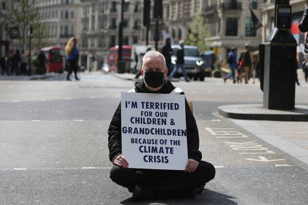 May 1, 2021, London, England, United Kingdom: An Extinction Rebellion activist blocks the road in Oxford Circus. Protester carries a sign that reads Ã¢â‚¬oeI am terrified for my children and grandchildren because of the climate crisis. London United Kingdom - ZUMAs262 20210501_zip_s262_022 Copyright: xTayfunxSalcix
