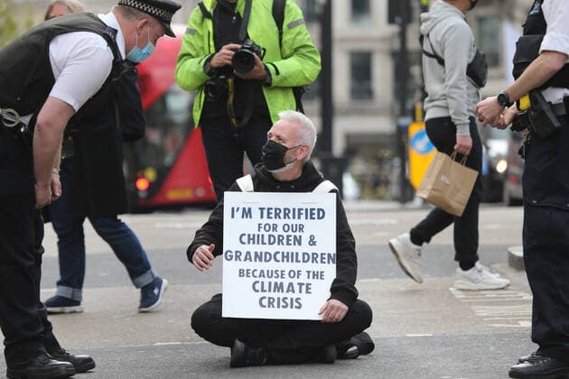 May 1, 2021, London, England, United Kingdom: An Extinction Rebellion activist blocks the road in Oxford Circus. Protester carries a sign that reads Ã¢â‚¬oeI am terrified for my children and grandchildren because of the climate crisis. London United Kingdom - ZUMAs262 20210501_zip_s262_023 Copyright: xTayfunxSalcix